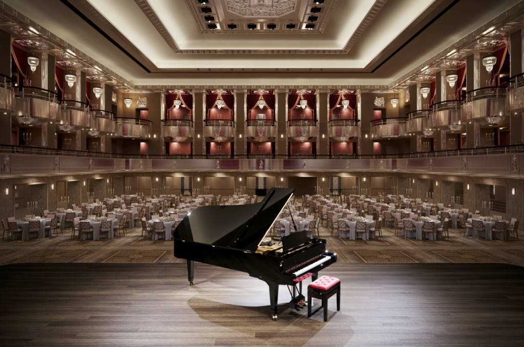 a piano in a room with tables and chairs